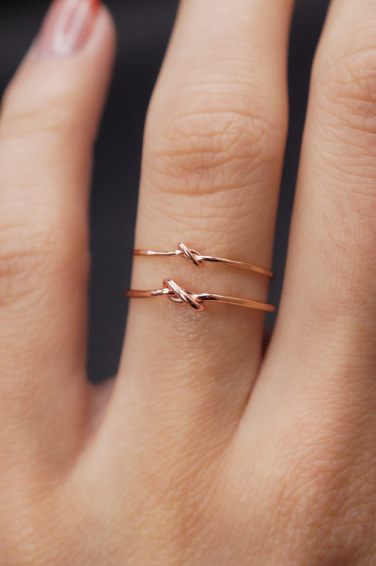 Modeled example of the Thick and Thin Closed Knot in 14k Rose Gold Fill on the ring finger.